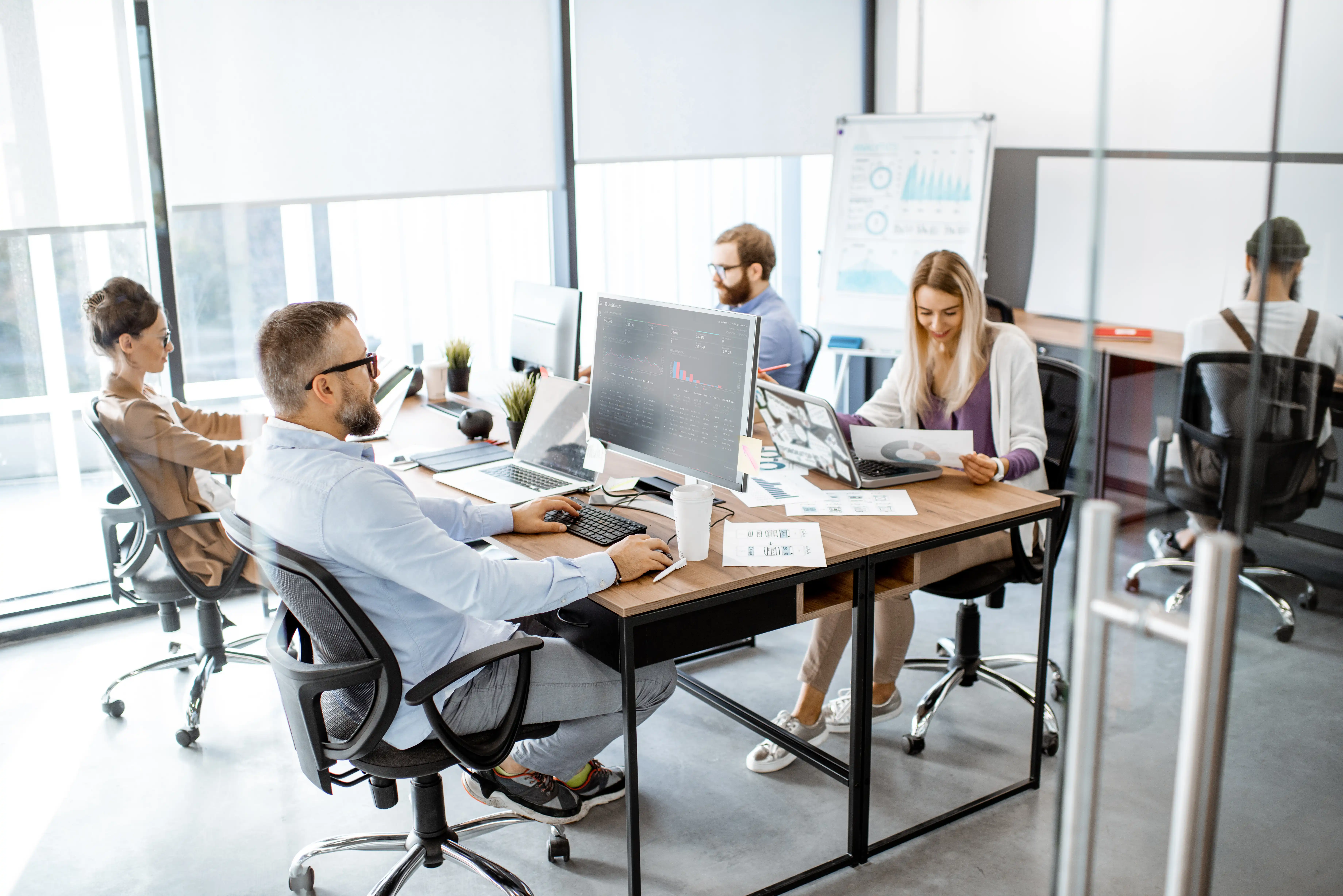 Employees working together in a bright, contemporary office setting